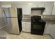 View of the kitchen featuring stainless steel refrigerator and black oven at 1457 Richland Sw Rd, Atlanta, GA 30310
