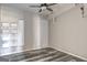 Finished basement featuring laminate flooring, modern shelving, and a ceiling fan at 976 Buckhorn Bnd, Locust Grove, GA 30248