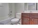 Well-lit bathroom with a combined shower and bathtub and wooden vanity at 976 Buckhorn Bnd, Locust Grove, GA 30248