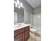 The bathroom has a combined shower and bathtub with a wooden vanity at 976 Buckhorn Bnd, Locust Grove, GA 30248