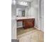 Bathroom showcasing a vanity with a dark wood finish, tile flooring, and a doorway to another room at 976 Buckhorn Bnd, Locust Grove, GA 30248