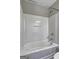 Clean white bathtub with a shower in a well-lit bathroom at 976 Buckhorn Bnd, Locust Grove, GA 30248