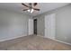 Bedroom with ceiling fan, plush carpeting, and multiple doorways for easy access at 976 Buckhorn Bnd, Locust Grove, GA 30248