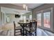 A dining room with a round table, chairs, and a view of the living room and back deck at 976 Buckhorn Bnd, Locust Grove, GA 30248