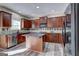 Kitchen featuring dark wood cabinets, stainless steel appliances, and a central island with seating at 976 Buckhorn Bnd, Locust Grove, GA 30248