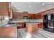 Spacious kitchen showcasing dark wood cabinets, a kitchen island, and stainless steel appliances at 976 Buckhorn Bnd, Locust Grove, GA 30248