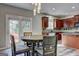 A modern kitchen with stainless steel appliances and a dining area with a view of the back deck at 976 Buckhorn Bnd, Locust Grove, GA 30248