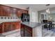 This kitchen features dark wood cabinets, stainless steel appliances, and a large island at 976 Buckhorn Bnd, Locust Grove, GA 30248