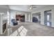 Open living room leading into kitchen and dining area with ceiling fan and a beautiful fireplace at 976 Buckhorn Bnd, Locust Grove, GA 30248