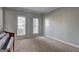 This is a room with two windows, neutral paint, carpet, and a piano at 976 Buckhorn Bnd, Locust Grove, GA 30248