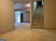 Open finished basement with carpet and stairs to the upper floors at 232 Darwish Dr, Mcdonough, GA 30252