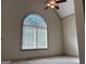 Bedroom featuring vaulted ceilings and a large arched window, creating a bright and airy space at 232 Darwish Dr, Mcdonough, GA 30252