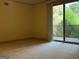 Bedroom featuring carpeted floor, large sliding door, and a balcony with trees at 232 Darwish Dr, Mcdonough, GA 30252