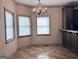 Bright dining area with tile flooring, a chandelier, and views from three windows at 232 Darwish Dr, Mcdonough, GA 30252