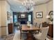 Dining room with wood table, chandelier, and view of the Gathering room fireplace at 232 Darwish Dr, Mcdonough, GA 30252