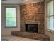 Cozy brick fireplace featuring two windows on either side at 232 Darwish Dr, Mcdonough, GA 30252