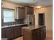 Kitchen features a large stainless steel refrigerator, a central island and well-lit cabinets and countertops at 232 Darwish Dr, Mcdonough, GA 30252