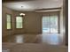 Open concept living room with tile flooring, large windows and sliding glass doors to pool at 232 Darwish Dr, Mcdonough, GA 30252