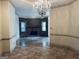 Living room featuring a decorative chandelier, stone fireplace, and tile flooring at 232 Darwish Dr, Mcdonough, GA 30252