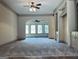 Spacious living room featuring neutral carpet, archways, and built-in cabinets at 232 Darwish Dr, Mcdonough, GA 30252