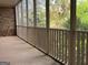 Relax on this screened porch with brick accents and wooden railing overlooking a lush, green yard at 232 Darwish Dr, Mcdonough, GA 30252