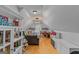 This unique attic features hardwood floors, built-in shelves, a sitting area, and a chandelier at 417 Harper Rd, Mcdonough, GA 30252