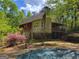View of the backyard of a multi-story house with a pool, partially covered at 417 Harper Rd, Mcdonough, GA 30252