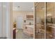 A luxurious bathroom featuring a corner tub, a tile surround, and a separate glass-enclosed shower at 417 Harper Rd, Mcdonough, GA 30252