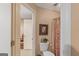 This bathroom includes a patterned shower curtain, a toilet with storage, and a doorway to another room at 417 Harper Rd, Mcdonough, GA 30252