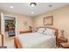 This bedroom features neutral walls, an ensuite bathroom, and a glimpse into the exercise room at 417 Harper Rd, Mcdonough, GA 30252