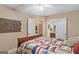 This sunny bedroom offers neutral walls, wood floors, and access to two separate bathrooms at 417 Harper Rd, Mcdonough, GA 30252