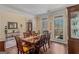 Formal dining room features hardwood floors, wainscoting, and a large table with seating for six at 417 Harper Rd, Mcdonough, GA 30252