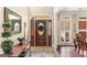 Elegant foyer with decorative glass front door, tile flooring, and stylish table and mirror at 417 Harper Rd, Mcdonough, GA 30252