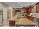 Close-up of a kitchen island with granite countertops, a built-in sink, and custom wood cabinetry at 417 Harper Rd, Mcdonough, GA 30252