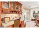 Inviting eat-in kitchen with desk, custom cabinets, granite countertops, and sun-filled doorway at 417 Harper Rd, Mcdonough, GA 30252