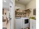 Well-organized laundry room with shelving, washer, dryer, and storage cabinets at 417 Harper Rd, Mcdonough, GA 30252