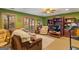 This cozy Gathering room features green walls, hardwood floors, and a view of the outdoors at 417 Harper Rd, Mcdonough, GA 30252