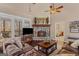 Inviting living room with stone fireplace, hardwood floors, leather furniture, and natural light at 417 Harper Rd, Mcdonough, GA 30252