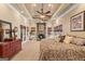 Large primary bedroom with a fireplace, sitting area, trey ceiling, and warm natural lighting at 417 Harper Rd, Mcdonough, GA 30252