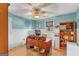 Home office featuring wood floors, wainscoting, natural light, and a ceiling fan for comfortable work environment at 417 Harper Rd, Mcdonough, GA 30252