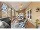 Covered outdoor patio with wood floors, ceiling fans, comfortable seating, and a grill at 417 Harper Rd, Mcdonough, GA 30252