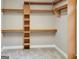 Walk-in closet with custom built-in wooden shelves and hanging rods for optimal organization and storage at 417 Harper Rd, Mcdonough, GA 30252