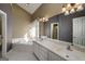 A serene bathroom featuring a soaking tub, dual vanities, and elegant lighting fixtures at 152 Wexford Ct, Stockbridge, GA 30281