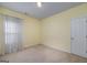 A light-filled bedroom with a neutral carpet and a bright window at 152 Wexford Ct, Stockbridge, GA 30281