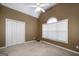 This bedroom offers neutral walls, a vaulted ceiling, and a large window at 152 Wexford Ct, Stockbridge, GA 30281