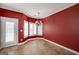 Bright breakfast nook with red walls, white trim, a chandelier and large windows at 152 Wexford Ct, Stockbridge, GA 30281