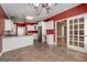 Spacious kitchen featuring a large island, stainless steel appliances, and red accent walls at 152 Wexford Ct, Stockbridge, GA 30281