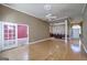 Open-concept living room with hardwood floors, white trim, and views of the dining room and entry way at 152 Wexford Ct, Stockbridge, GA 30281