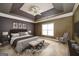 Staged main bedroom with tray ceiling, neutral tones, and decorative accents at 152 Wexford Ct, Stockbridge, GA 30281