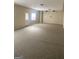 A large finished basement space with carpet flooring and a door leading to the exterior at 460 Ridgewood Dr, Fayetteville, GA 30215